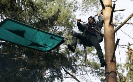 Click on image to see full-sized version Activist sets up tent