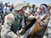 Iraqis go about their daily lives under the shadow of a hostile foreign military presence.