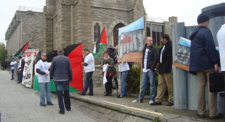 Protestors line the street outside the hotel